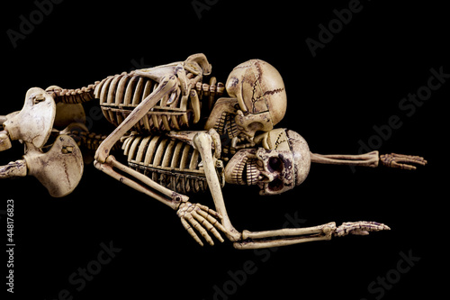 Halloween sex,Skeletons having sex on black background.