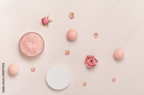 Aromatic crystals of sea salt with essential oil flower of rose. Spa composition with cosmetic bathroom product top view