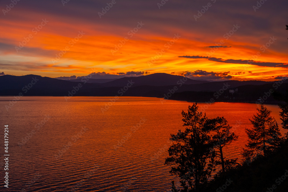 Obraz premium sunset over the dark lake