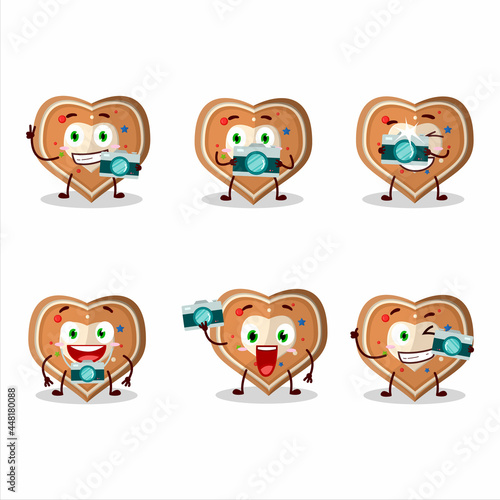 Photographer profession emoticon with gingerbread heart cartoon character © kongvector
