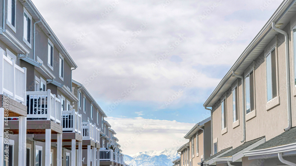 Pano Row of homes on a suburbs neighborhood with scenic lake mountain and sky views