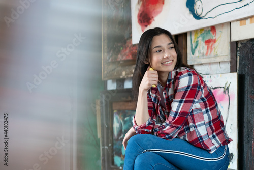 young beautiful woman pose in a plaid shirt in the studio