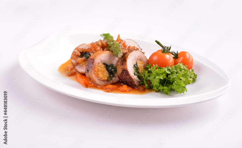 grilled chicken meat wrapped with pumpkin and vegetables roll with tomato sauces in white background for Christmas festival menu grilled chicken meat wrapped with pumpkin and vegetables roll with tomato sauces in white background for Christmas festival menu