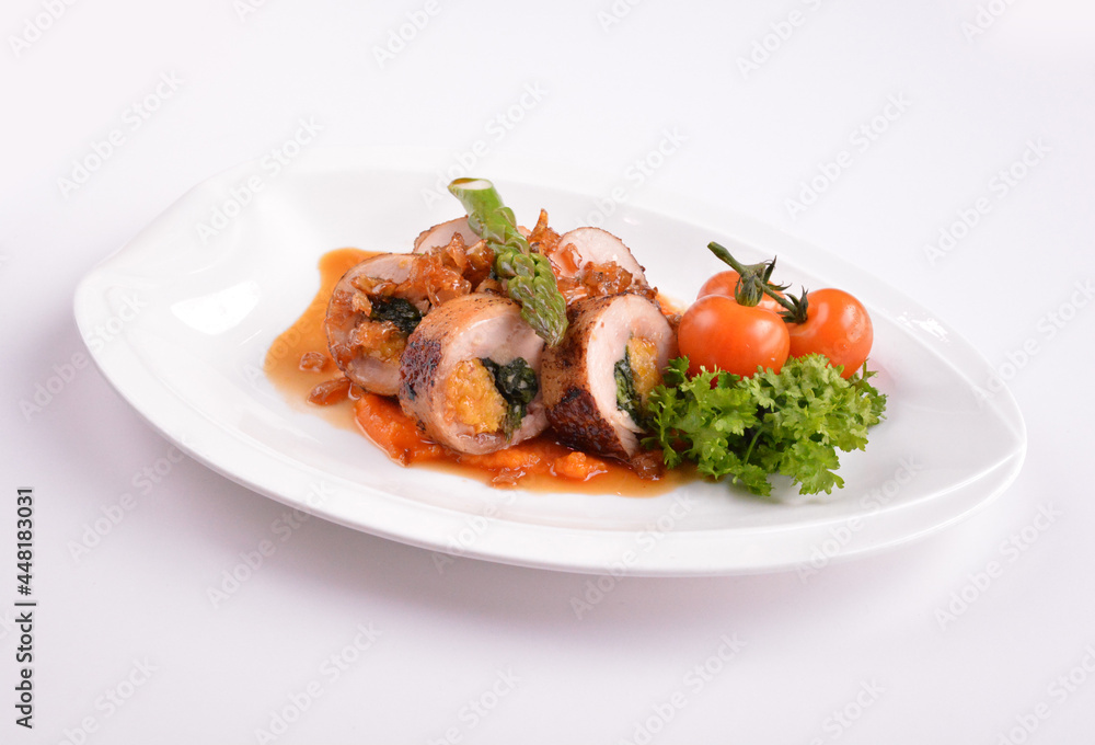 grilled chicken meat wrapped with pumpkin and vegetables roll with tomato sauces in white background for Christmas festival menu grilled chicken meat wrapped with pumpkin and vegetables roll with tomato sauces in white background for Christmas festival menu