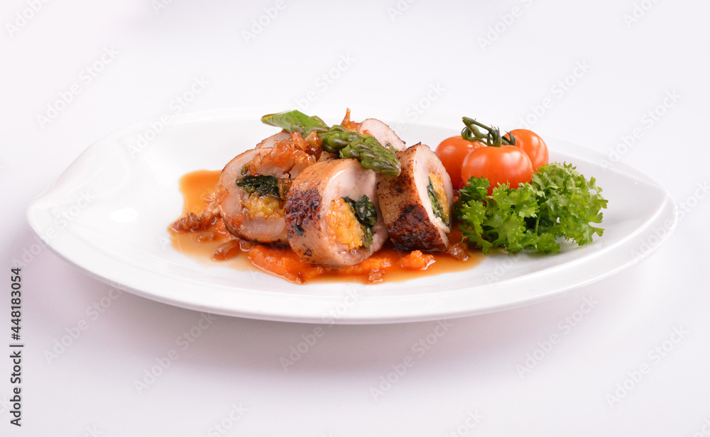 grilled chicken meat wrapped with pumpkin and vegetables roll with tomato sauces in white background for Christmas festival menu grilled chicken meat wrapped with pumpkin and vegetables roll with tomato sauces in white background for Christmas festival menu