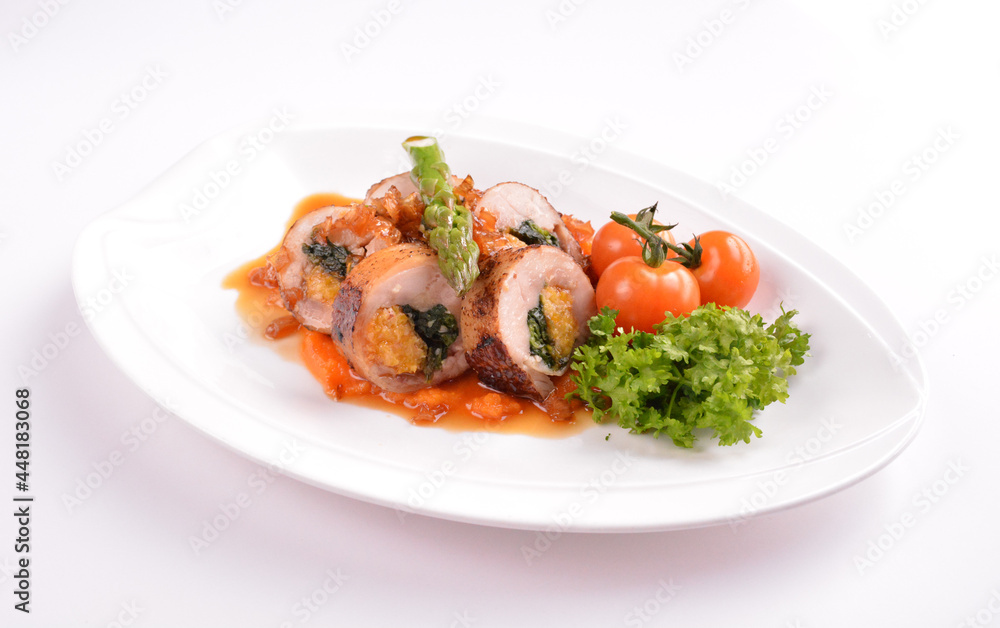grilled chicken meat wrapped with pumpkin and vegetables roll with tomato sauces in white background for Christmas festival menu grilled chicken meat wrapped with pumpkin and vegetables roll with tomato sauces in white background for Christmas festival menu