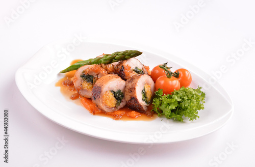 grilled chicken meat wrapped with pumpkin and vegetables roll with tomato sauces in white background for Christmas festival menu
