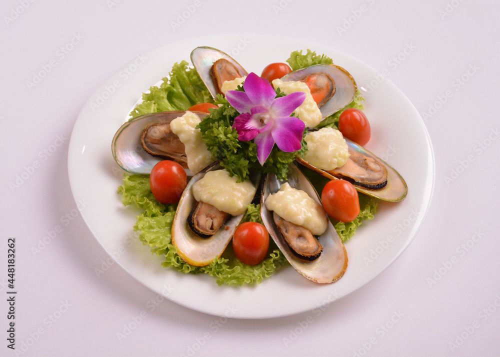 bbq baked cheese muscle on shell seafood with vegetable salad in white background for Christmas festival menu bbq baked cheese muscle on shell seafood with vegetable salad in white background for Christmas festival menu