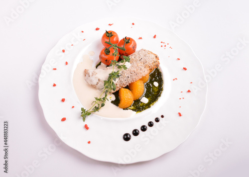 deep fried bake bread fish fillet seafood with orange and tomato in chef rosemary sauce and vegetables in white background for Christmas festival menu