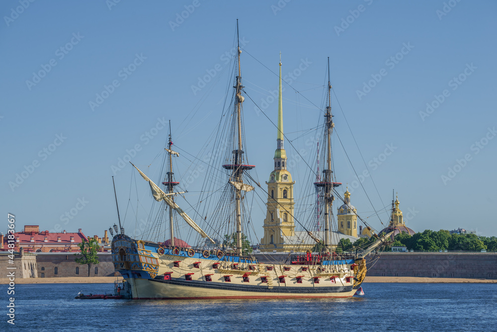 Russian old battleship Poltava against the backdrop of Peter and Paul Cathedral on July sunny morning, Saint Petersburg Russian old battleship Poltava against the backdrop of Peter and Paul Cathedral on July sunny morning, Saint Petersburg