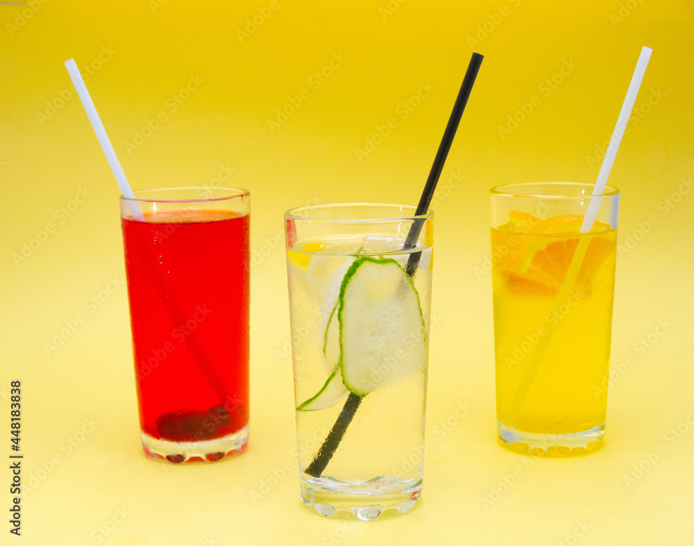 A set of summer refreshing cocktails with ice on a light background A set of summer refreshing cocktails with ice on a light background