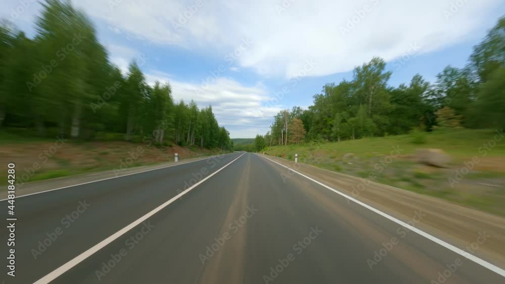 Long road with a hard surface. The route is among dense forests and hills. Long-distance travel, passenger transportation. Shooting in motion. High quality. 4k footage. Long road with a hard surface. The route is among dense forests and hills. Long-distance travel, passenger transportation. Shooting in motion. High quality. 4k footage.
