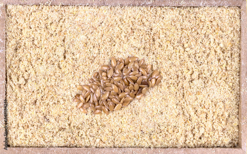top view of flour golden flaxseeds or golden linseed (Linum usitatissimum) in a rectangular wooden box