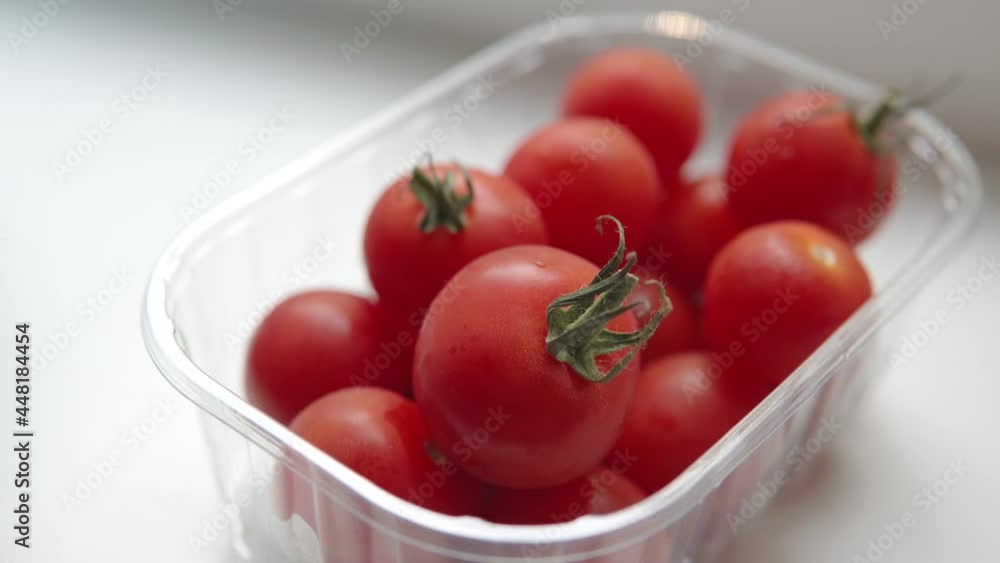 Small organic cocktail tomatoes or cherry tomatoes in a transparent plastic box. Small organic cocktail tomatoes or cherry tomatoes in a transparent plastic box.