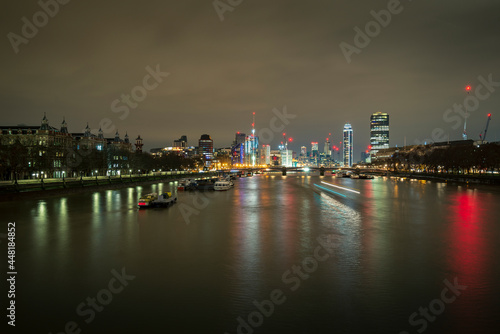 A long exposure photo of Thames river at night in London, UK