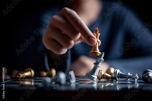 young child playing chess board game for strategy and intelligance game concept. 