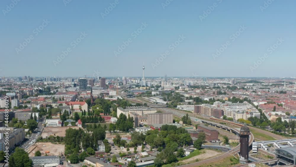 Sliding reveal of urban neighbourhood between railway track and river. Aerial view of large city. Berlin, Germany Sliding reveal of urban neighbourhood between railway track and river. Aerial view of large city. Berlin, Germany