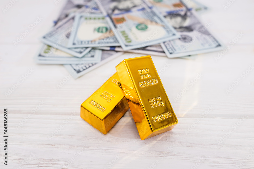 gold bars and dollars. gold bars and dollars.