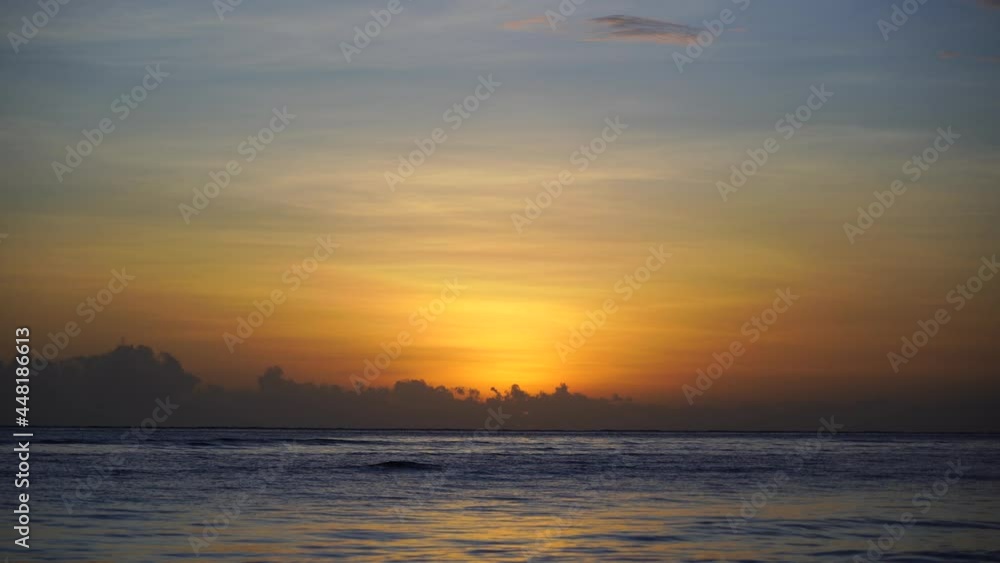 Beautiful sunrise over the Indian Ocean on the island of Zanzibar, Tanzania, east Africa. Travel and nature concept. Sun, blue sky and sea water Beautiful sunrise over the Indian Ocean on the island of Zanzibar, Tanzania, east Africa. Travel and nature concept. Sun, blue sky and sea water