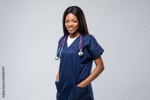 portrait of happy african american nurse isolated on white background