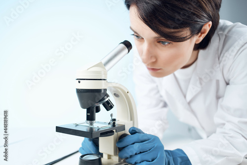 female laboratory assistant looking microscope diagnostics professional science