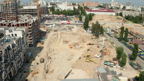 Aerial Flight Over a New Constructions Development Site. Construction Cranes. Aerial view of construction site. Aerial view of construction with special machines engeneers and huge cranes  photo