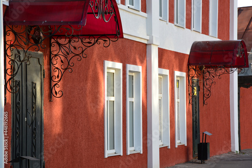 Red walls of the house. Building in the city in bright colors. City scene.