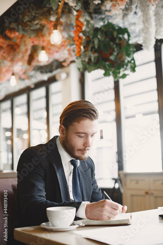 Man sitting with laptop in a cafe