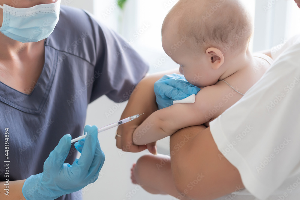 Pediatrician makes vaccination to small boy Pediatrician makes vaccination to small boy