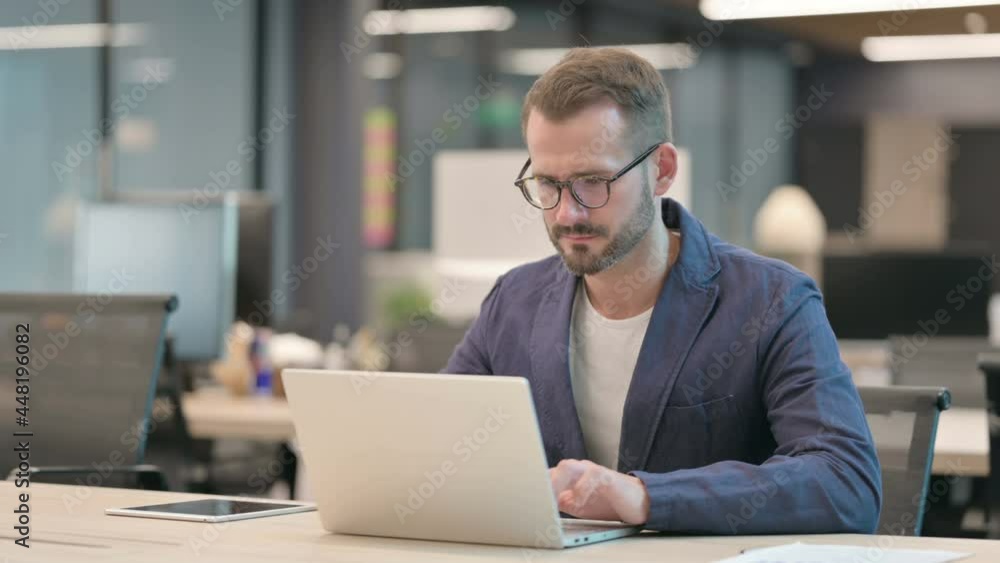 Middle Aged Businessman Working on Laptop in Office Middle Aged Businessman Working on Laptop in Office