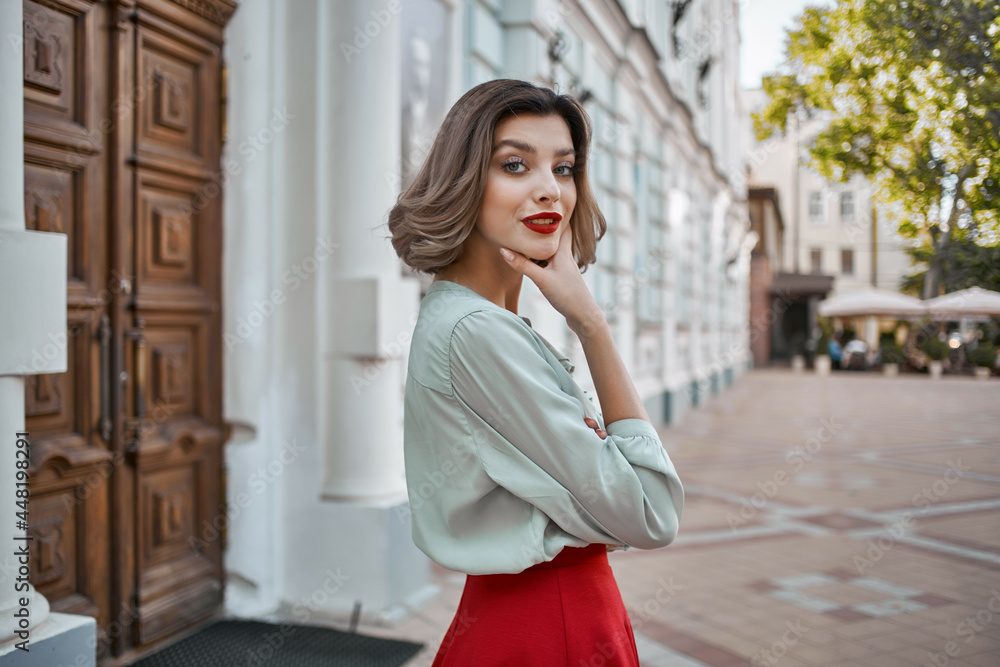 Fototapeta premium woman outdoors near building red lips walk