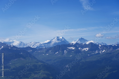 Panoramic view of Swiss alps with Mountains Eiger, Mönch (Monk) and Jungfrau (Virgin) on a beautiful sunny summer day seen from Brienzer Rothorn. Photo taken July 21st, Flühli, Switzerland.