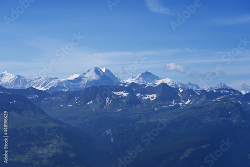 Panoramic view of Swiss alps with Mountains Eiger  M  nch  Monk  and Jungfrau  Virgin  on a beautiful sunny summer day seen from Brienzer Rothorn. Photo taken July 21st  Fl  hli  Switzerland.