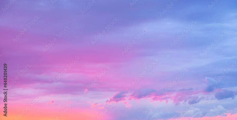 Sunset sky. Texture of bright evening sky during sunset. Dramatic blue and orange, pink colorful clouds at twilight time. Abstract weather nature background.