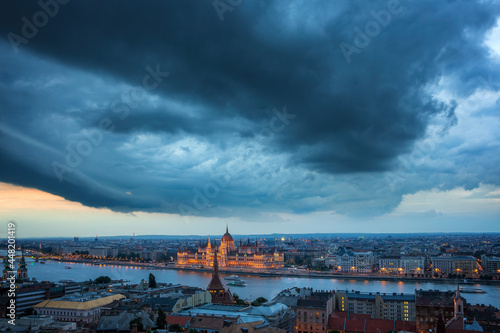 Photography Thunderstorm over the Parliament of Hungary at night.