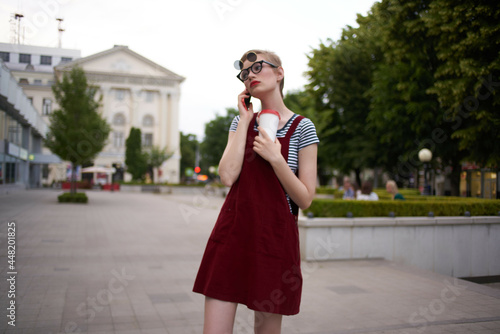 short haired woman wearing glasses walk glass with drink rest © SHOTPRIME STUDIO