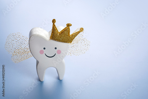 National Tooth Fairy Day. Children tooth fairy. Cute tooth with wings, a crown. photo