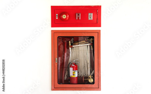 Fire fighting equipment for fire protection. Emergency button and fire alarm bell
on a white plaster wall. concept of building safety