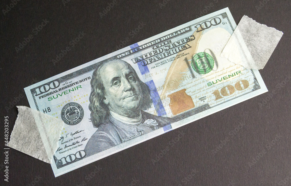 souvenir dollar banknote attached to the black background with tape souvenir dollar banknote attached to the black background with tape