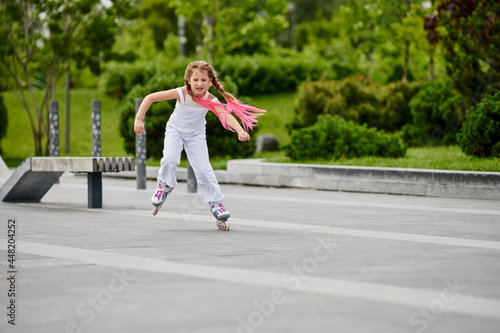 Cute little child girl on roller skates