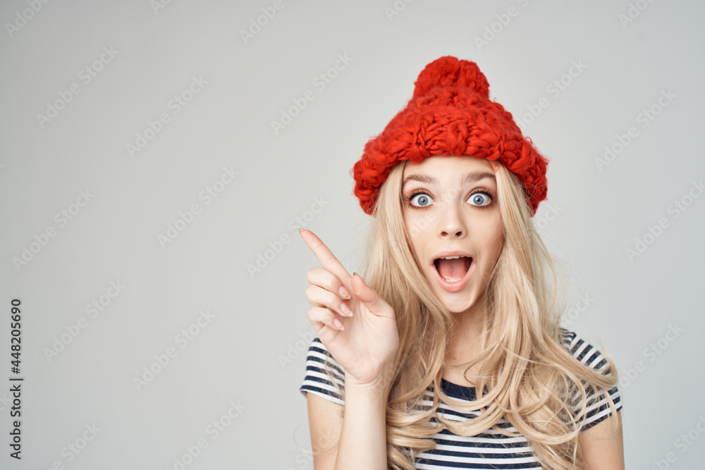 cheerful blonde in a red hat gesturing with her hands emotions cheerful blonde in a red hat gesturing with her hands emotions