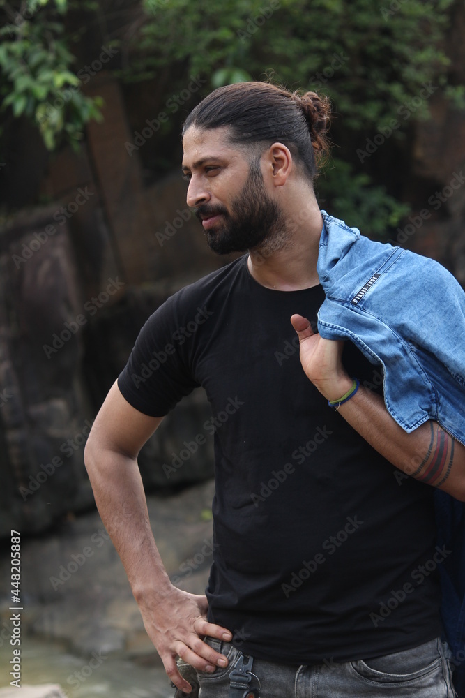 Handsome attractive man at river bank with river on background, looks at camera with calm and smiling expression. Handsome attractive man at river bank with river on background, looks at camera with calm and smiling expression.