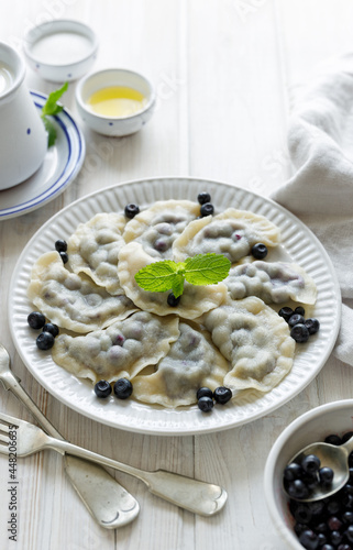 Blueberry dumplings on a white plate. Traditional home dish