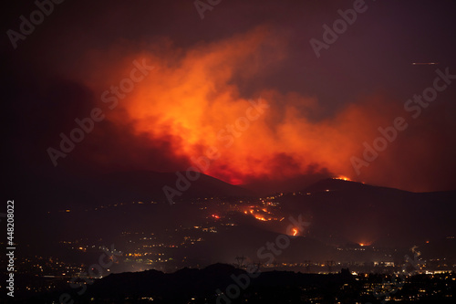 A nighttime wildfire tears through the hills of California.