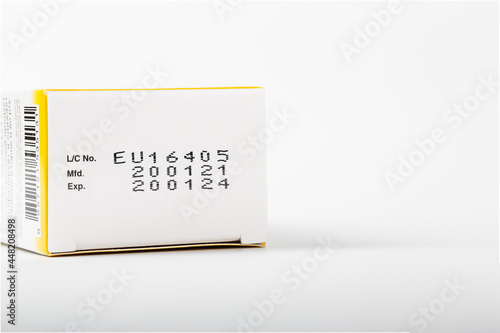 Instruction of lot number, manufacturing date, and expiry date label of a product on the bottom lid of the package with isolated white background and copy space.
