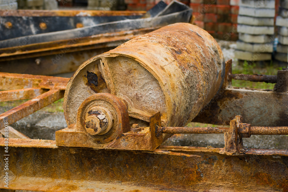 A rusty conveyor belt pulley from an old crusher A rusty conveyor belt pulley from an old crusher