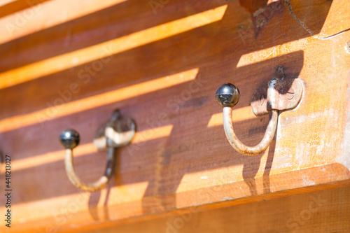Clothes hooks on a wooden plaque