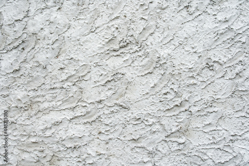 The texture of a gray plastered wall with pronounced stucco. Flat lay of the frame. Template for the designer