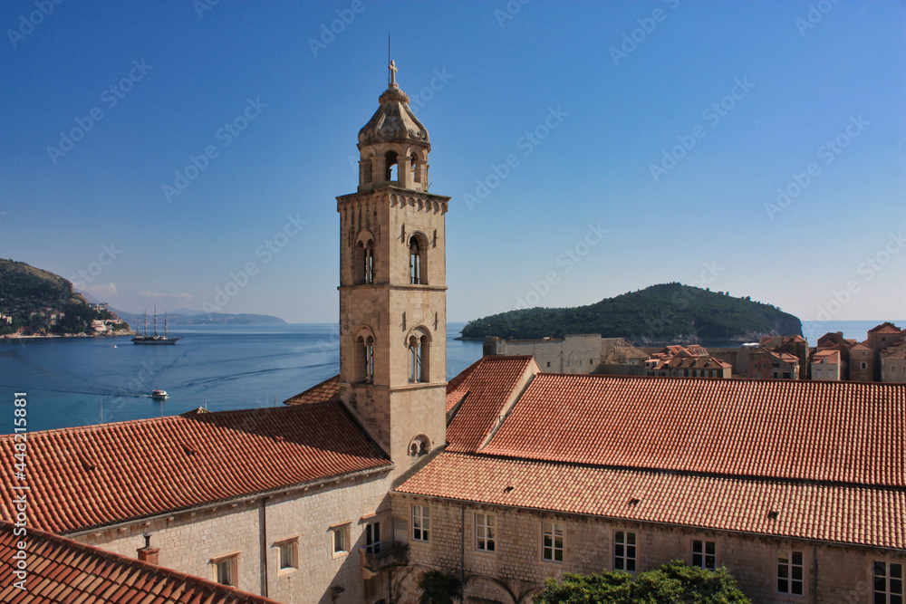 View to the Dubrovnik harbor with a church and a sailing boat in the background, Dalmatia region of Croatia