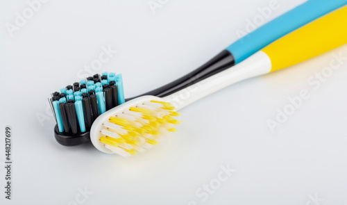 Blue-black and white-yellow toothbrush. Oral health. Personal hygiene.